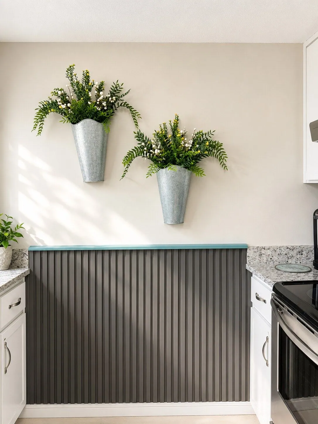 Kitchen breakfast bar with granite counters, slatted panelling and galvanised metal wall planters